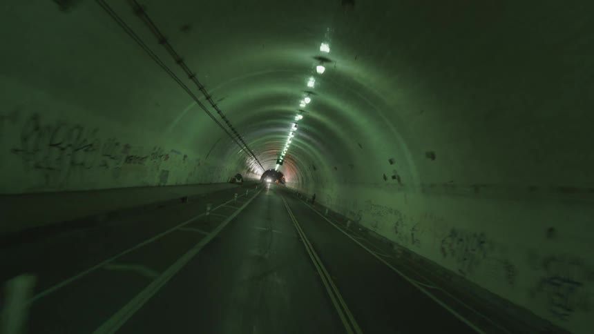 A car at the end of a long tunnel