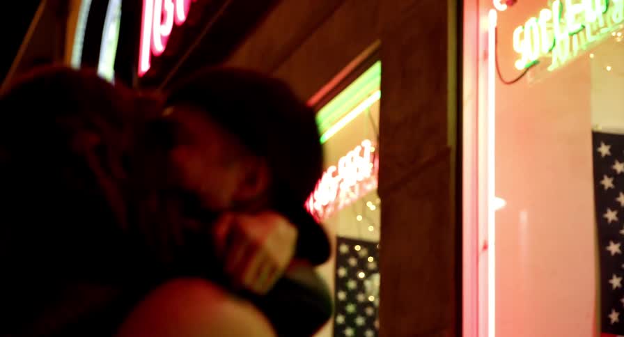 Two people are outdoors at night having fun