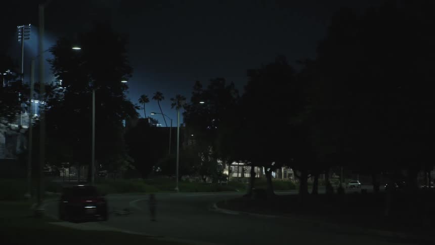 A lit up stadium in a city