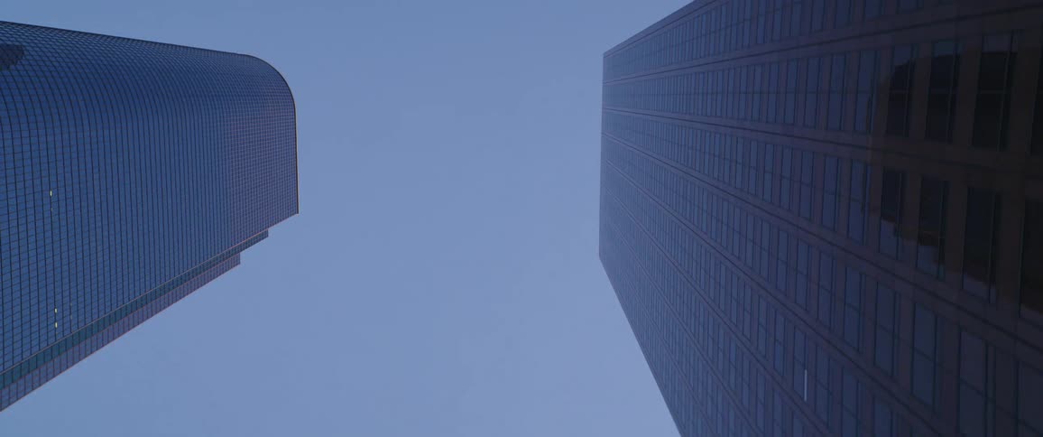 A pair of skyscrapers reach into the sky in a metropolis during the day