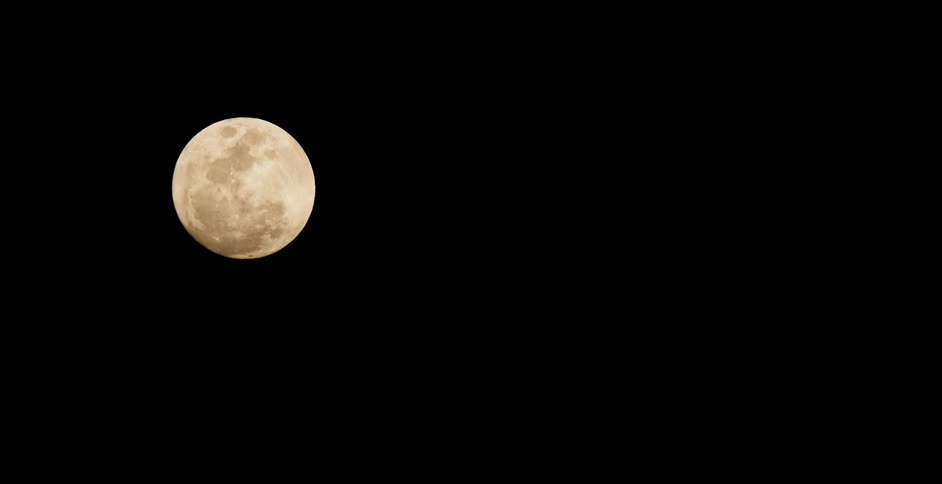 Clouds passing by a full moon at night