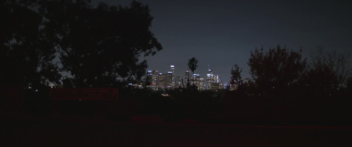 Lights of the citys downtown skyline at night seen from the outskirts