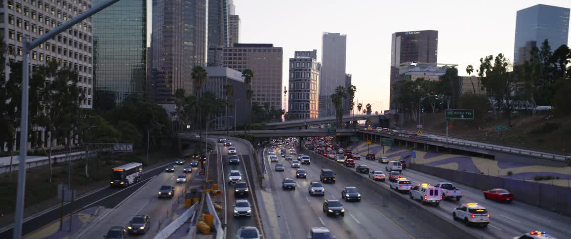 Aerial view of vehicular traffic on the highway of a city at sunset
