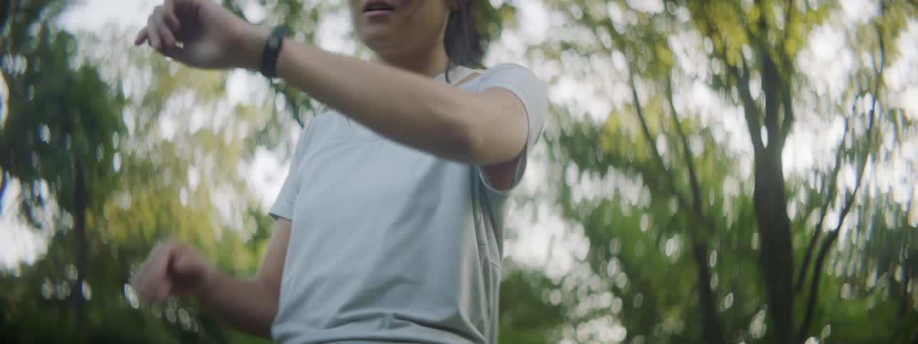 A woman looks at her watch and then starts to run