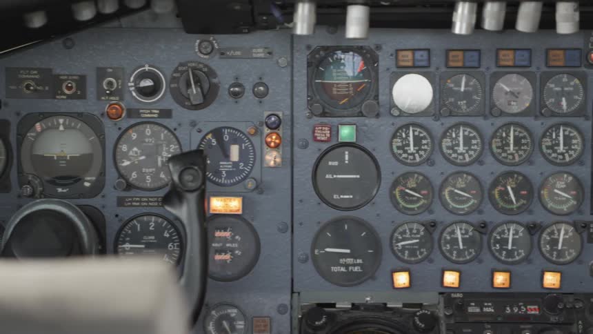The interior of a planes cockpit with gauges displays and indicator lights