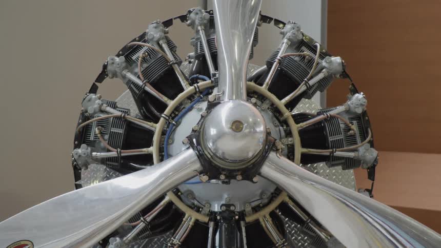 Close up of the silver propellers on an aircraft engine on exhibit