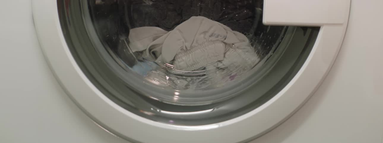 Clothing tumbles inside of a front loading washing machine