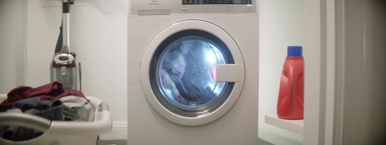 Clothes are spinning in a washer machine