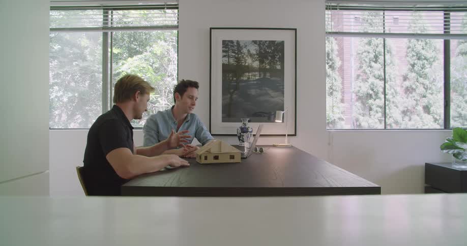 Two men are sitting in a room together