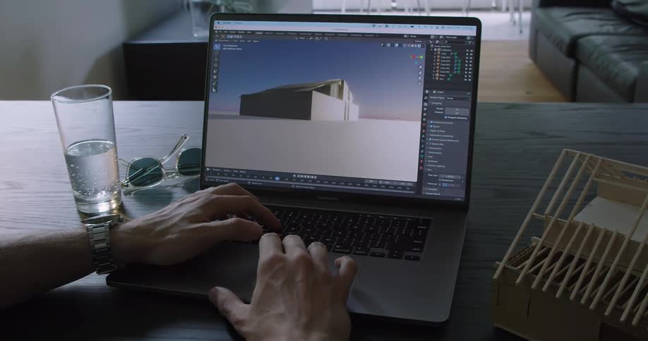 A man sits at home and works on his laptop
