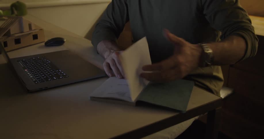 A man working late at home on his laptop at night