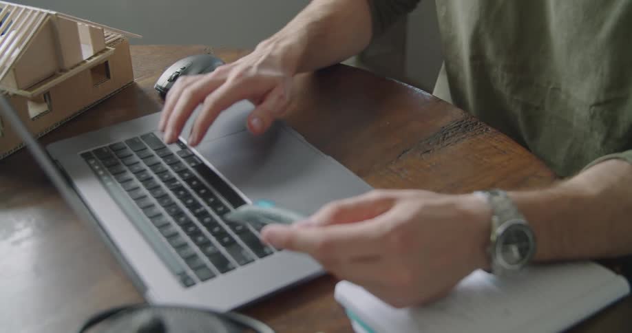 A man at a laptop types in his credit card details