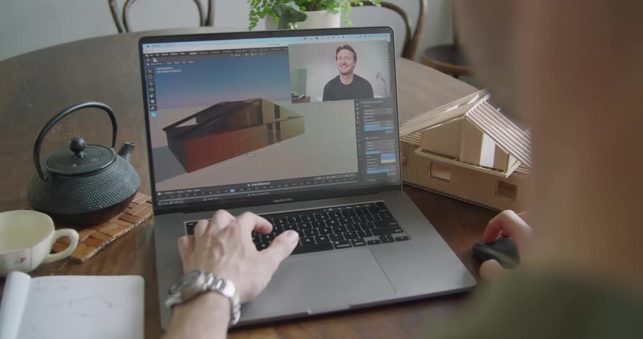 Two people talking together through a video call while working in a game engine