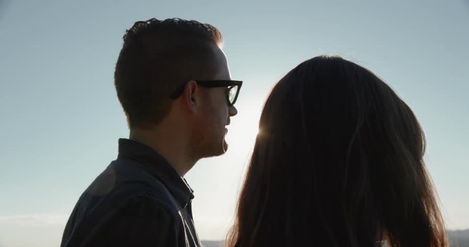 Man and woman talking outside on bright sunny day