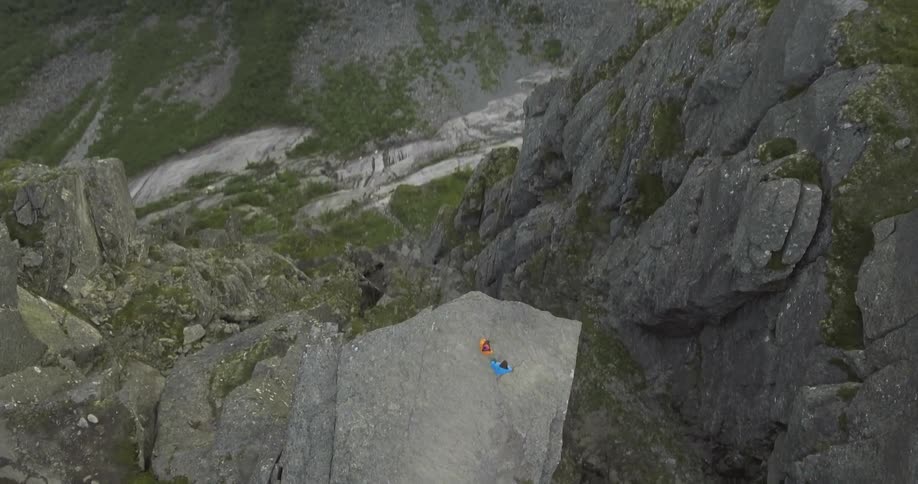 Two people are on the edge of a cliff