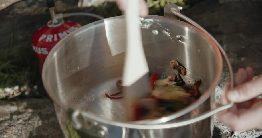 A pan of vegetables is stirred