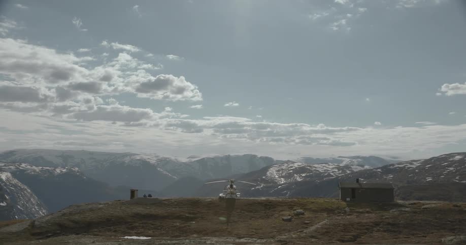 A small house sits on top of a mountain