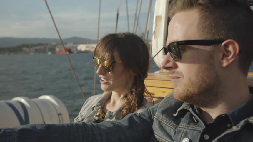A man and women talk as they sail on a boat