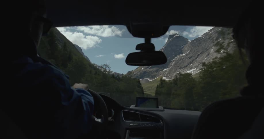 People driving down highway with view of beautiful mountains
