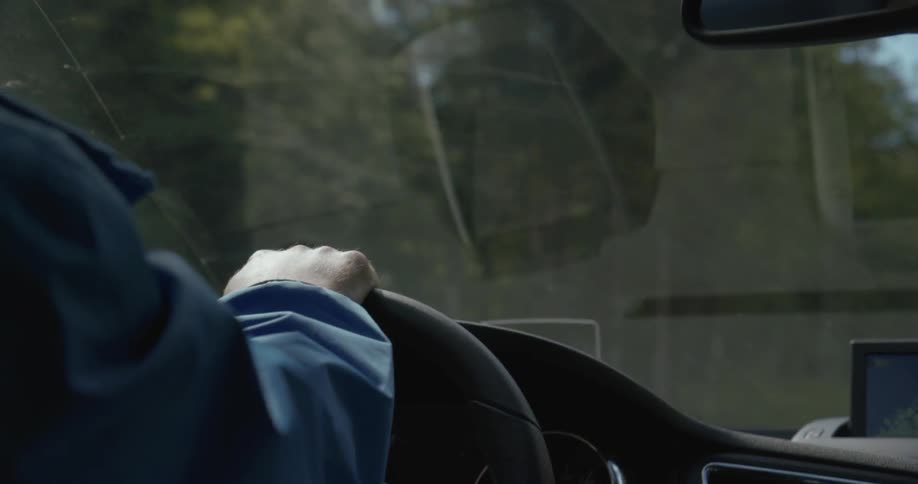 Close up of a person steering a vehicle driving