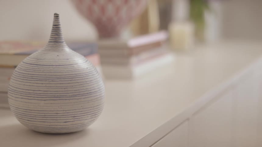 A close up of a ceramic object on a cabnet