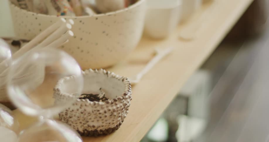 A table with bowls jars hourglasses and cups