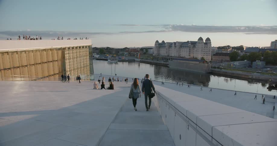 People are walking down stone steps near a city