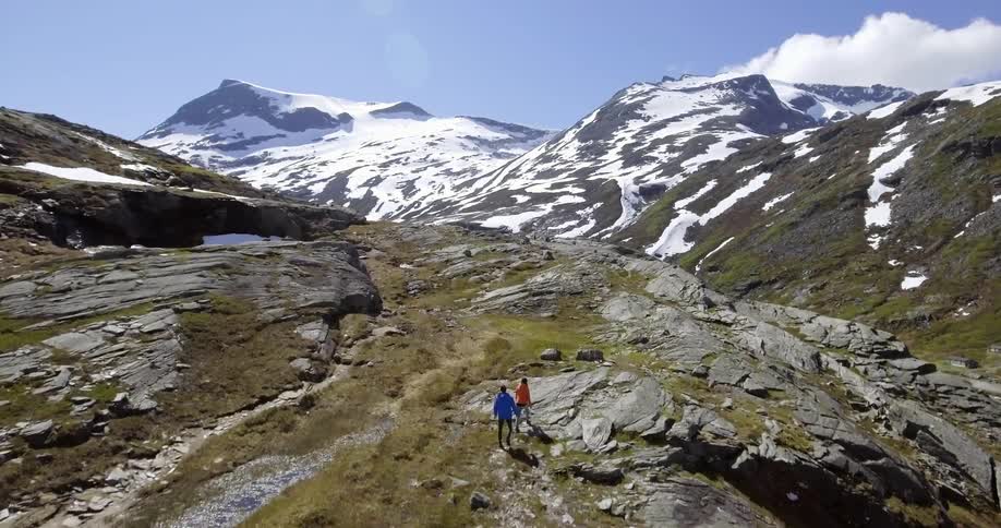 Two people are hiking on the top of a mountain