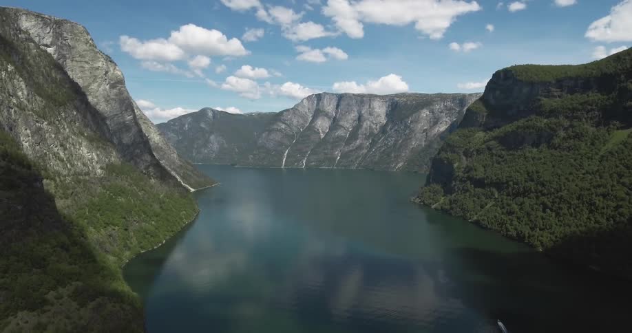 A lake sits between a mountain range