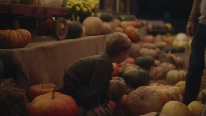 A family playing with pumpkins