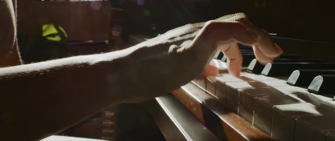 A person is playing the piano indoors