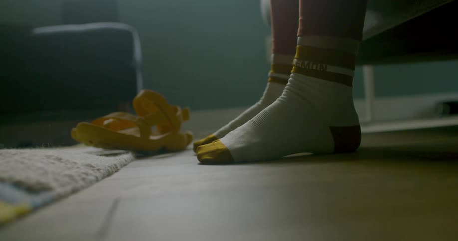 Person sits in a room wearing yellow and white socks