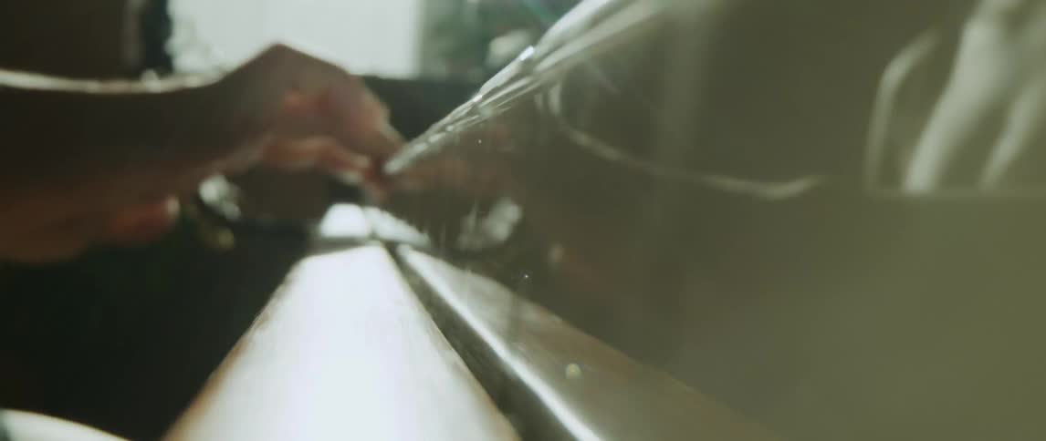 A woman sits and plays keys on a piano