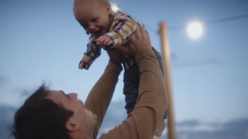 A father holding his son in the air