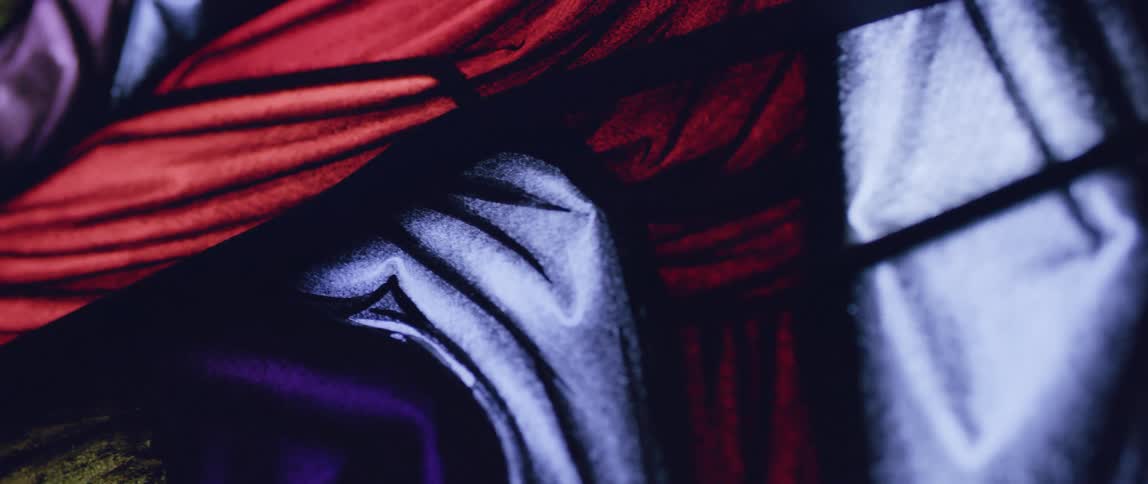 Close up of the colorful panels of a stained glass window