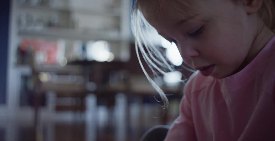 Young girl sitting on the floor in a room at home