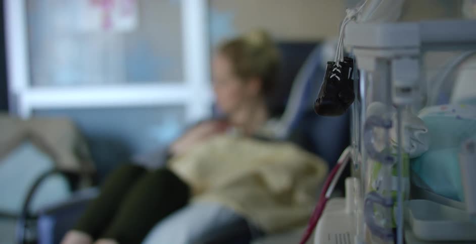 Mom holds her baby in the hospital