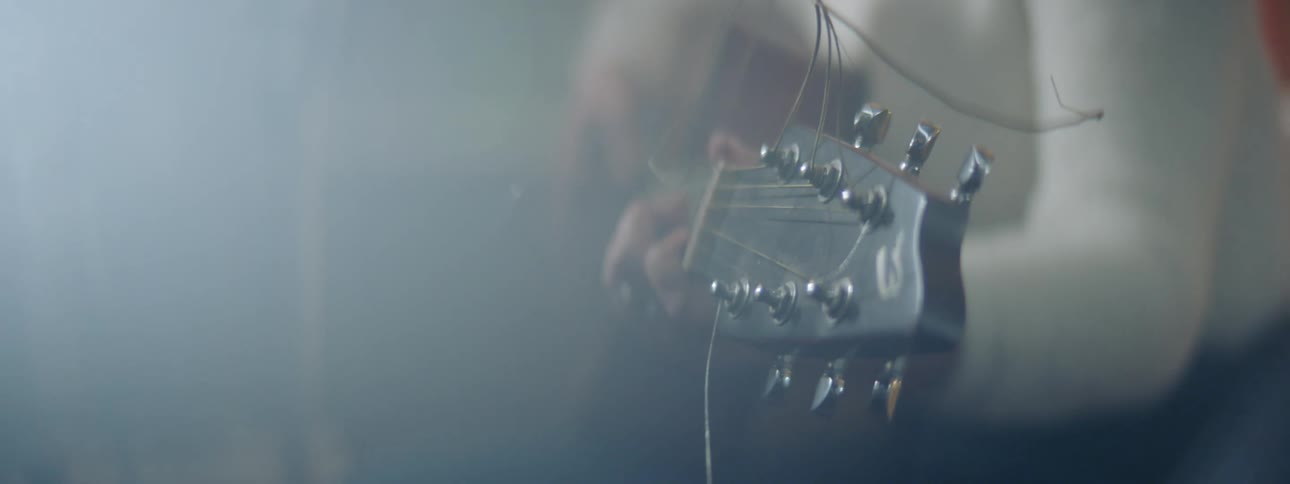 A person is playing guitar indoors