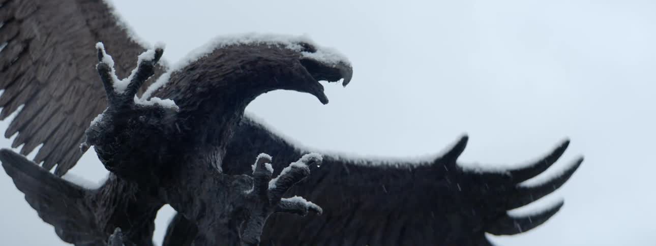 Snow covered eagle statue on a winter day