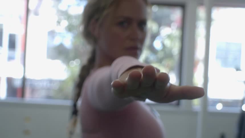 A woman stretching in a gym