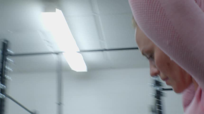 A woman walks through a gym