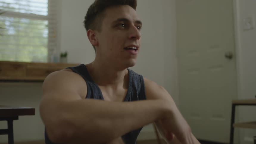 Man reclines in floor working out with a soccer bar