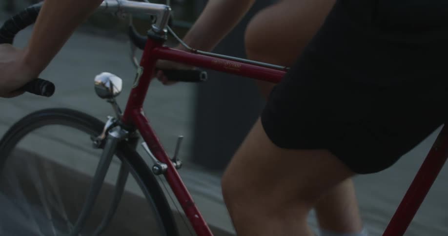 A cyclist rides a bicycle along a city road during the day