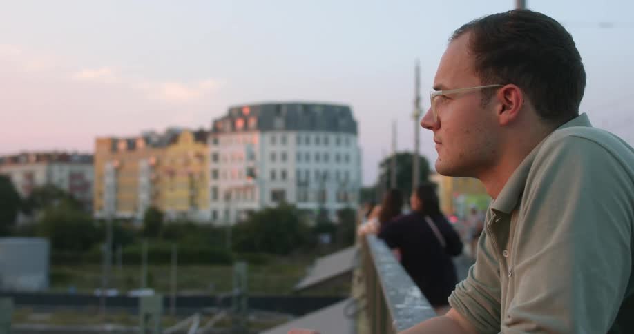 A man is watching the sunset outdoors