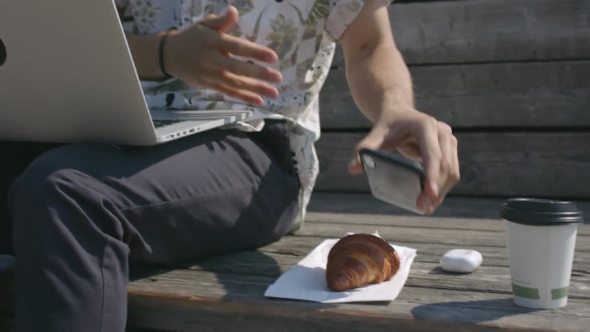A person putting their phone down next to food