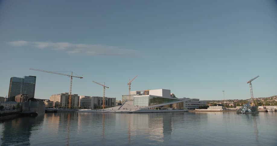 The water is still near a city shoreline