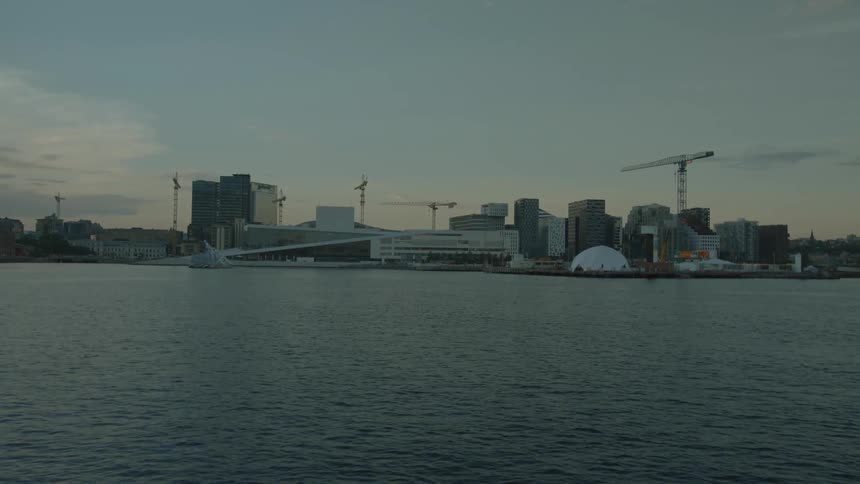 A coastal city as seen from the water at dawn