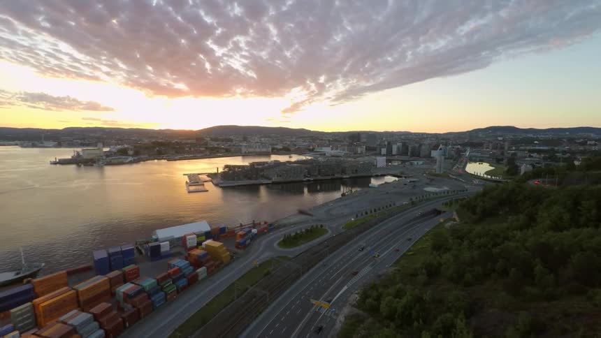 The sun rises over a waterside city