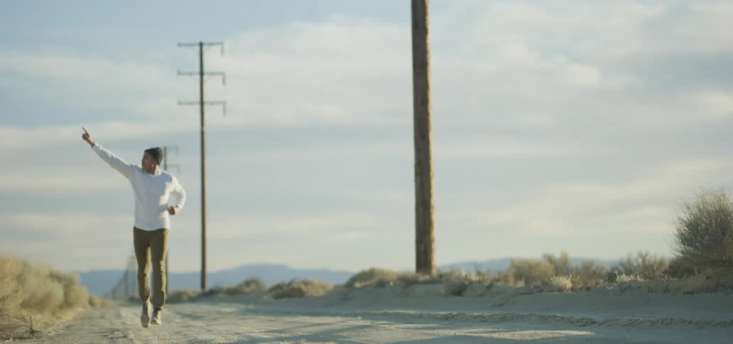 A man is jogging outdoors in a rural area