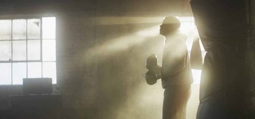 A man is boxing inside a house